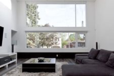 15 a laconic modern living room accentuated with dark floors and furniture and a fluffy rug