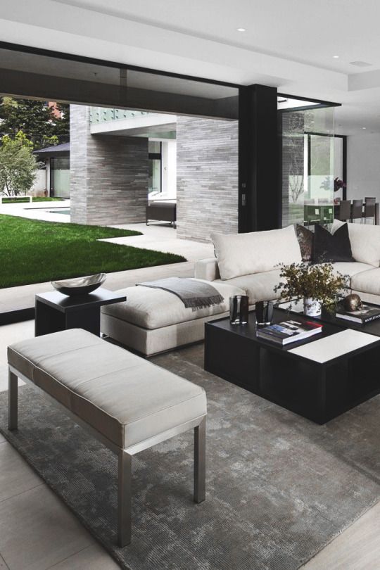 a laconic modern space in black, white and grey, chic textiles and clean-lined furniture