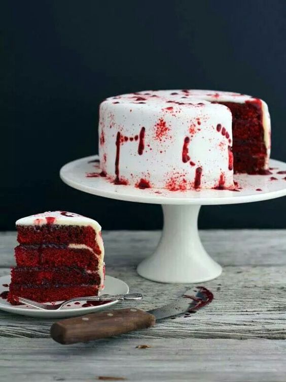 a vampire cake in deep red and with blood on the white frosting