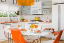 17 a contemporary kitchen with orange countertops, a lamp and chairs