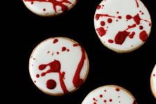 17 blood splatter cookies are ideal for a dessert table at a vamprire Halloween party