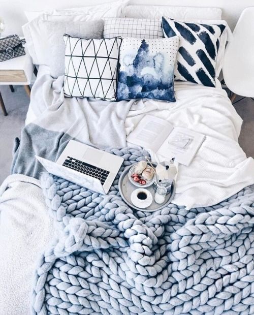 a gorgeous serenity blue chunky knit blanket and blue printed pillows for a cool look
