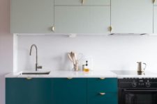 19 a modern kitchen with teal floor cabinets and very pale green ones above looks bold and very interesting