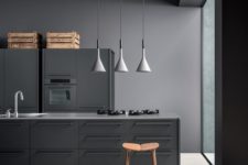 20 a grey metal industrial kitchen with crates and pendatn lamps done in concept of a moody space
