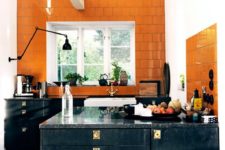 20 a vintage black kitchen with a bold orange tile backsplash extended above for a bold contrast