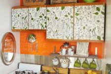 21 a cheerful kitchen with a leaf print and a bold orange backsplash for a colorful touch