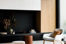 21 a modern living room with light-colored wood panels, black and white and laconic furniture