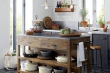 21 a reclaimed wood kitchen island contrasts with the dark furniture and tiles around