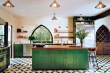 22 bold green cabinets and a kitchen island are balanced with metalllic lamps and wooden countertops