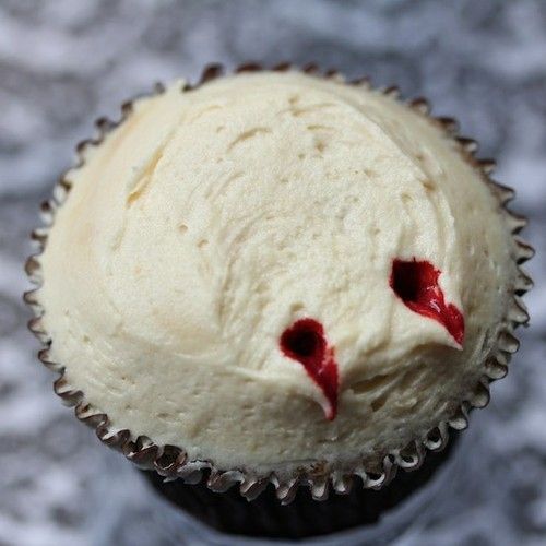 just poke two fang marks into cupcake icing and add red food coloring for your very own vampire cupcakes