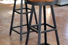 22 reclaimed wood stools with black metal framing add both a rustic and an industrial feel