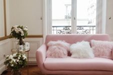 23 a pink sofa with faux fur pillows makes this space more playful and girlish