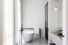 24 a chic space with geo tiles, grey bathtub floor, a concrete vanity, a black shower and wooden floors