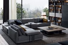 24 a modern living room done in grey and black, filled with natural light and lots of storage space