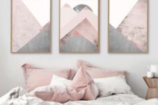 24 blush pillows and a geometric artwork with blush tones create a soft feel in the bedroom