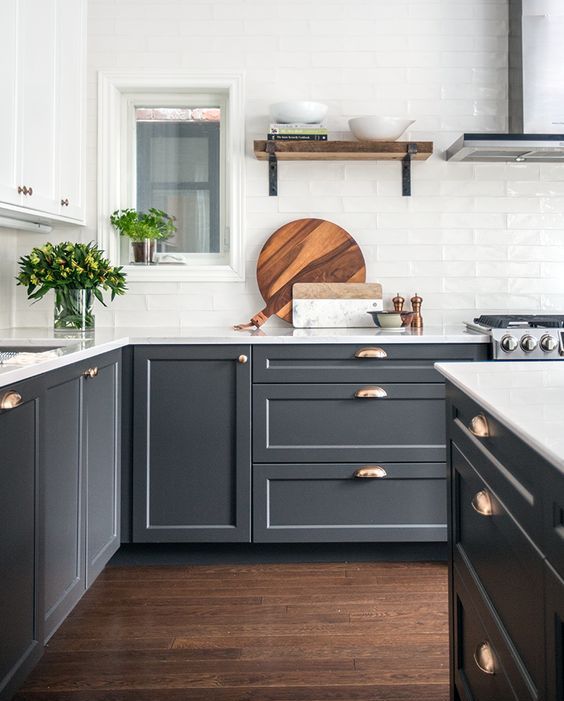 graphite grey cabinets are made more elegant with metallic handles and white tabletops