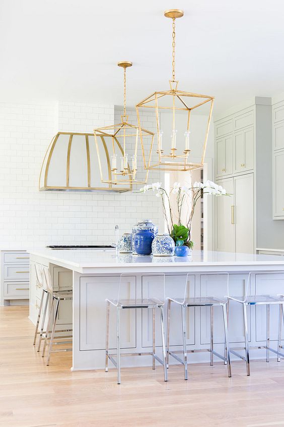large brass lamps and a hood with a touch of brass are bolder than stainless steel chairs