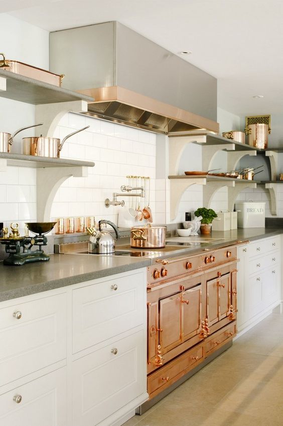 a vintage-inspired copper cooker takes over the space, and stainless steel touches contrast it
