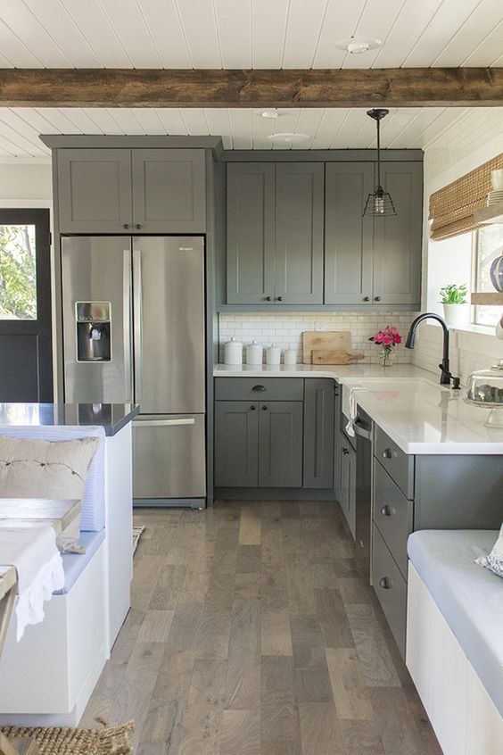 graphite grey vintage kitchen with white countertops and tiles looks peaceful and relaxed