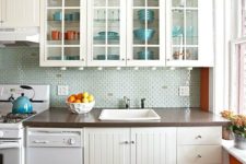 27 neutral kitchen cabinets stand out in orange walls and bold blue plates