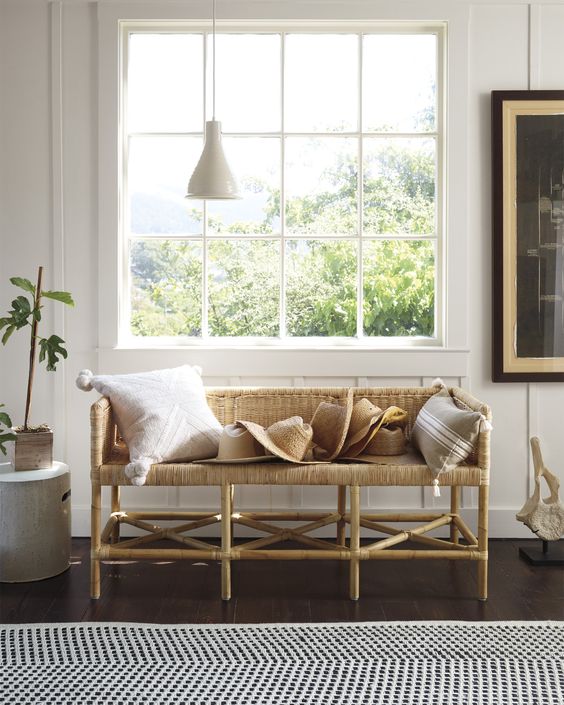 a wicker bench is a gorgeous idea for an entryway and it brings a cozy feel