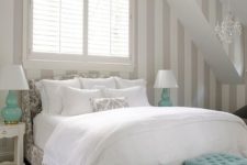 a soft-looking guest bedroom with white as the main color, light grey as additional and a couple of turquoise accents