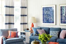 blue is the main color in this coastal space, and cream pairs perfectly with it, white some coral and red touches highlight the color scheme