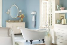 light blue is the main color in the bathroom, cream and white are additional ones, orange and greens are added for a colorful touch