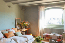 neutral grey green is the main color, beige is an additional shade and touches of orange enliven the space