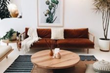 white and cream are taken as main colors, shades of brown and neutral wood add style and softness, and a burnt orange sofa is used for a colorful touch