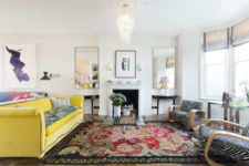 01 This gorgeous living room is done with a bold yellow sofa, animal print chairs, a gorgeous vintage chandelier and an antique fireplace