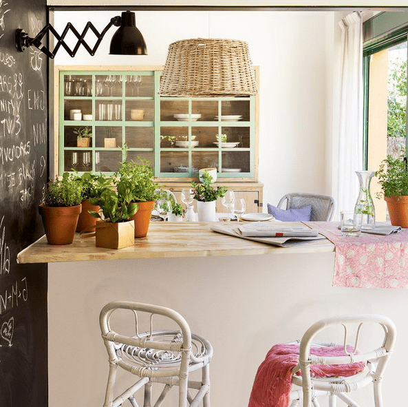 There's a bar counter with a window to the kitchen, the bar is available from both sides and the ktichen doesn't interfere with the space