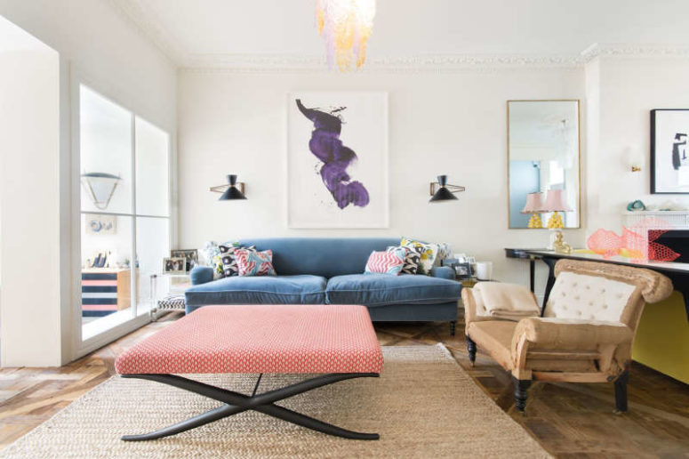 This is the second part of the living room, with a blue sofa and a cool upholstered coffee table or ottoman This is the second part of the living room, with a blue sofa and a cool upholstered coffee table or ottoman