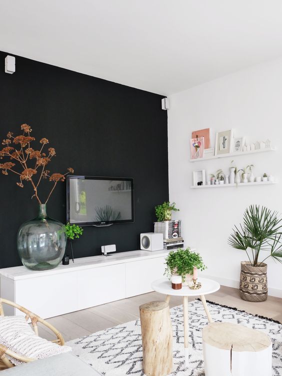 a Scandinavian space done in neutrals and creamy shades, and one black wall for a bold accent, some boho touches