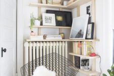 03 a cozy reading nook with a comfy chair and bookshelves over the radiator is a warm and cozy space