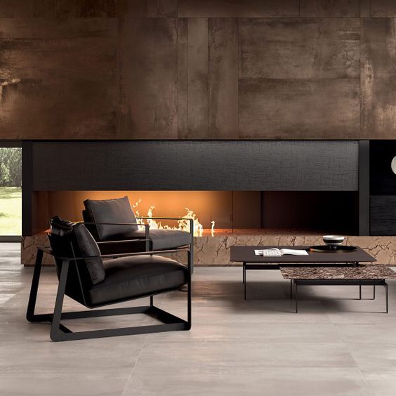 a luxurious living room in dark shades with a built-in fireplace and dark furniture for a cool look