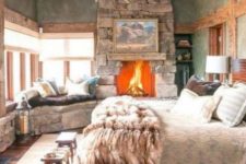 a stone clad fireplace brings coziness to this cabine bedroom and makes it welcoming