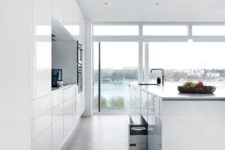 03 all-white minimalist kitchen with sleek cabinets and great views with a large kitchen island