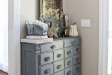 03 an apothecary cabinet painted slate looks chic and adds a vintage touch to your entryway
