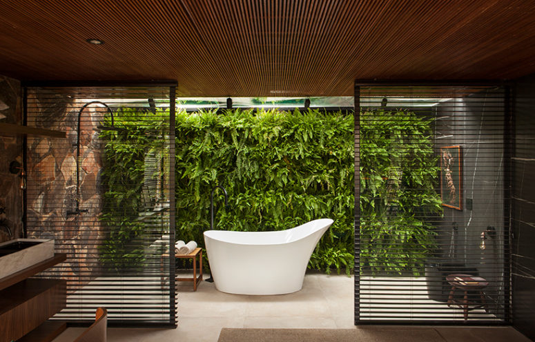 gorgeous indoor living wall in a bathroom The bathroom also features a gorgeous living wall and wooden screens to divide the sink zone from the bathing one