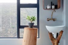 04 The bathroom features a tree stump stand and a branch sink holder, which remind you that it’s an eco cabin