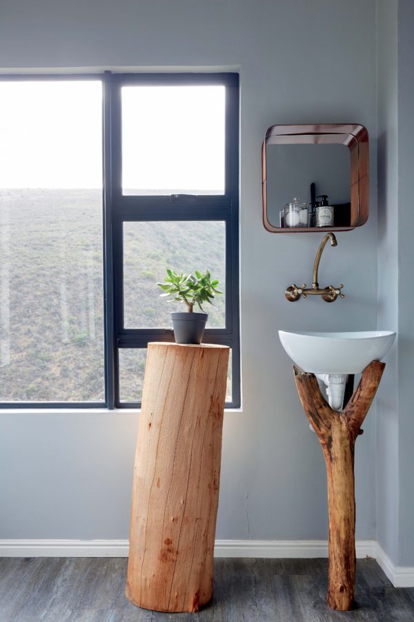 The bathroom features a tree stump stand and a branch sink holder, which remind you that it's an eco cabin The bathroom features a tree stump stand and a branch sink holder, which remind you that it's an eco cabin