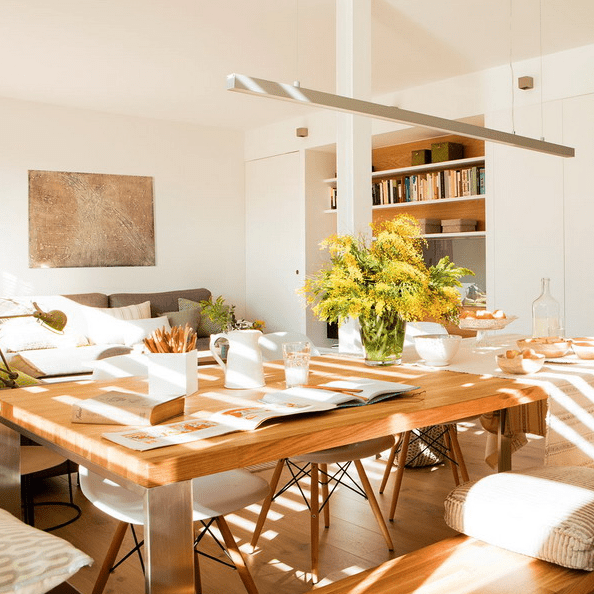 The dining area features a comfy table that can accomodate several people, modern chairs and a hanging lamp The dining area features a comfy table that can accomodate several people, modern chairs and a hanging lamp