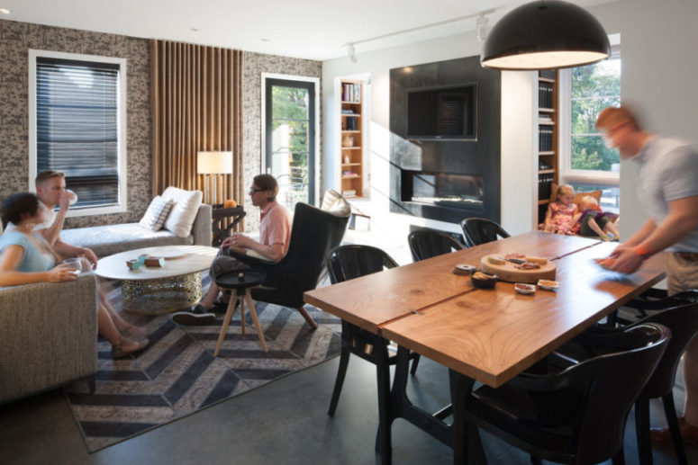 The dining space and living room are fused in one, there's comfortable upholstered furniture and a wooden dining table The dining space and living room are fused in one, there's comfortable upholstered furniture and a wooden dining table