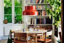 04 The dining space is done with a wwooden dining set and a round table, a number of bookshelves in the corner stores a lot of books