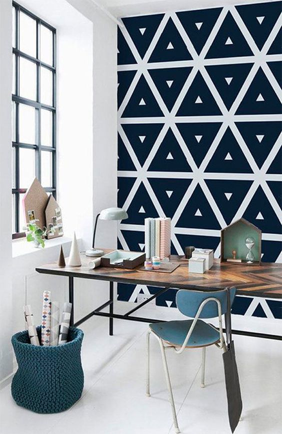 a Scandinavian home office with a geometric black wall that will make it eye-catchy and interesting
