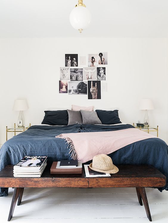 a bedroom with a rustic stained bench makes a statement in this space