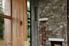 04 a chalet-inspired retreat features a stone-clad fireplace with firewood storage for an interesting touch