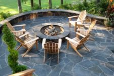 04 a stylish stone patio with a round firepit and simple wooden chairs to enjoy comfort