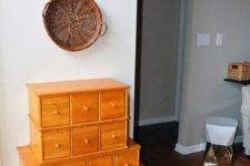 04 an antique apothecary cabinet in bold orange for accentuating an entryway